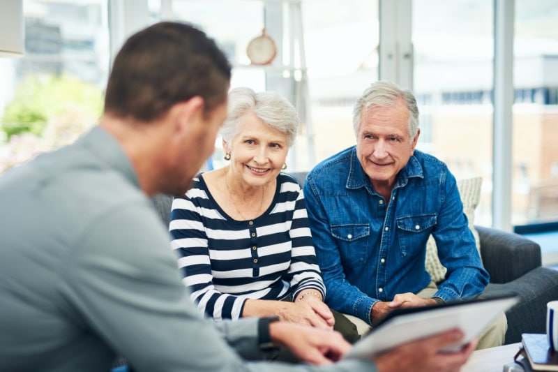 Should I Get an 80 or 95 Percent Furnace? Photo of a senior couple having a consultation in their home.